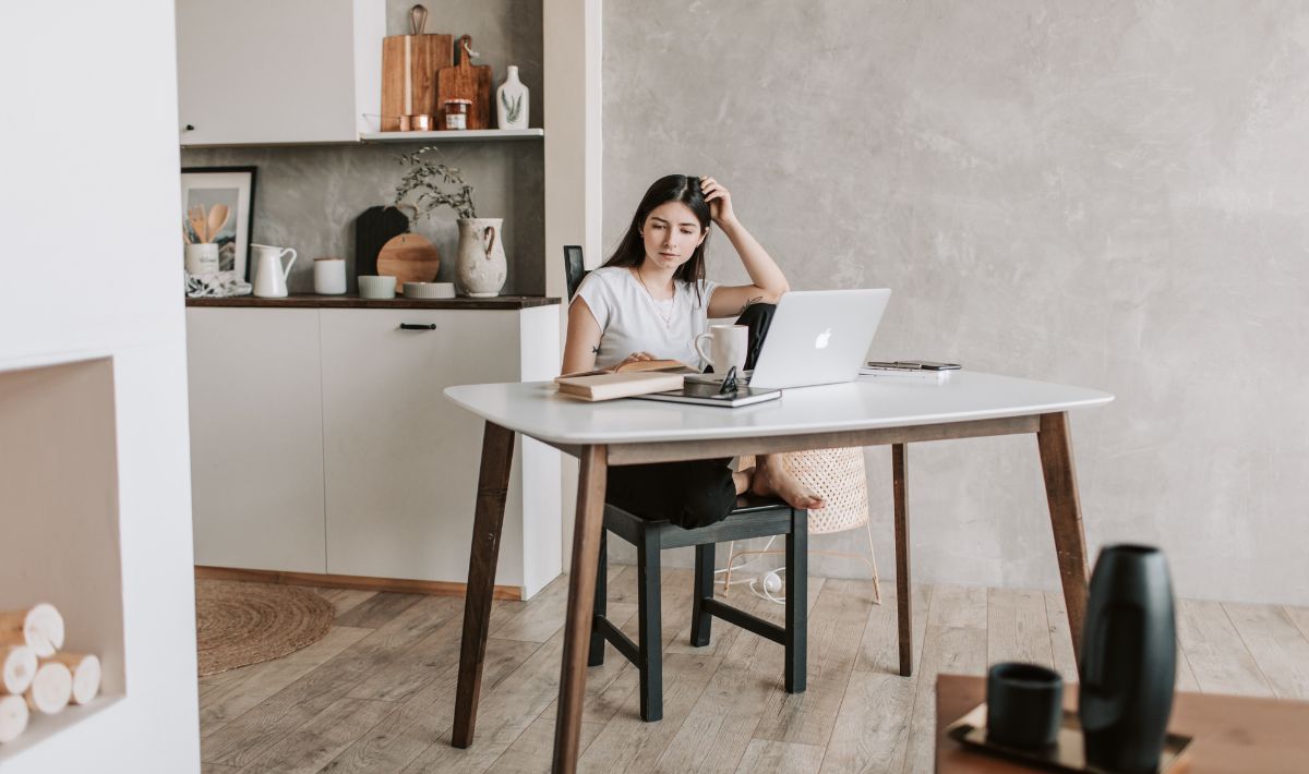 Woman sitting at desk in front of laptop