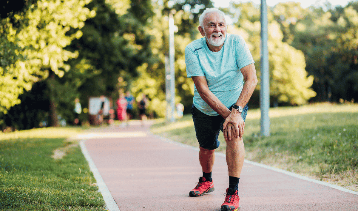 Older male stretching left leg forward and leaning on knee
